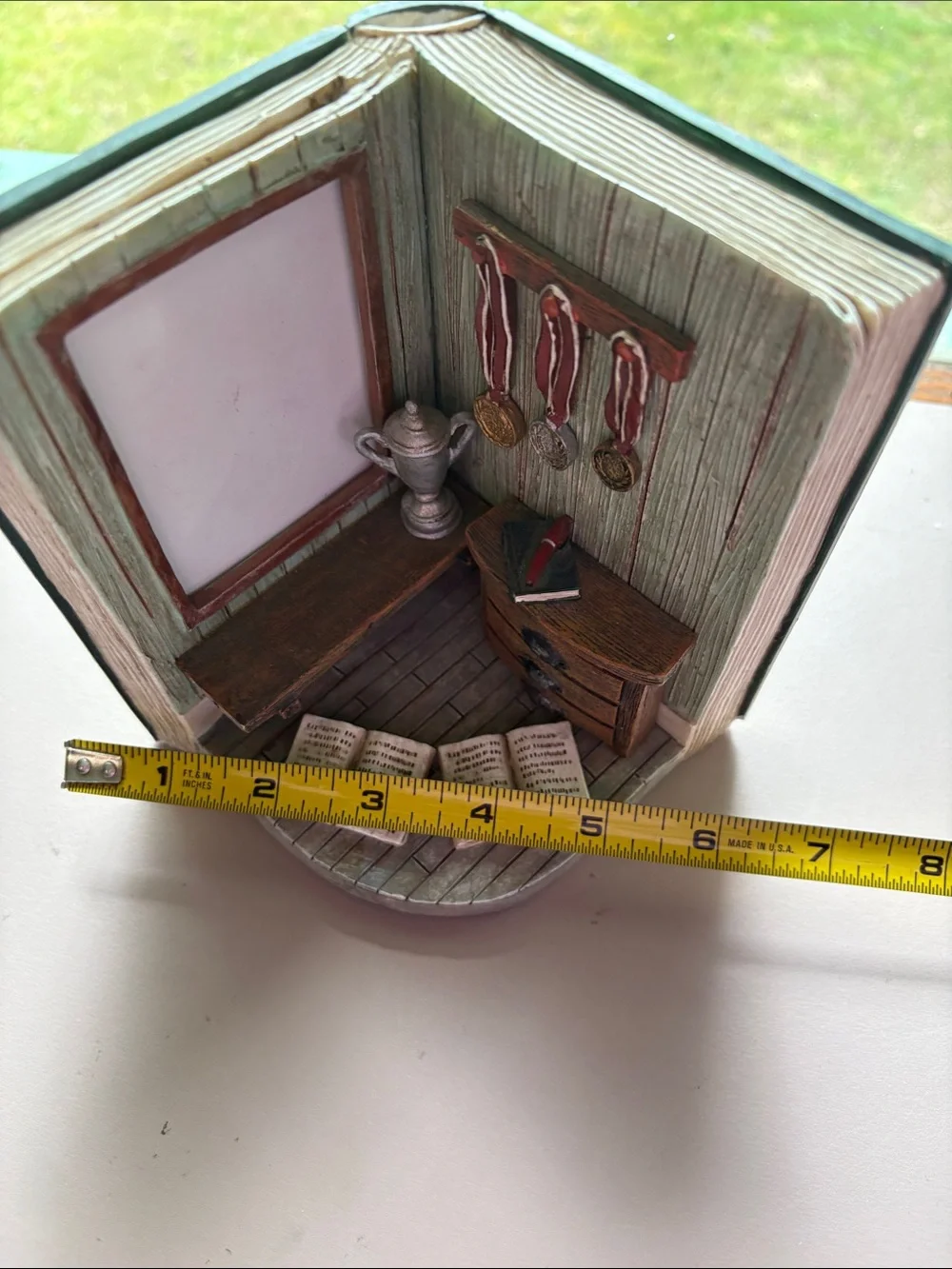Picture frame decoration with open book and awards